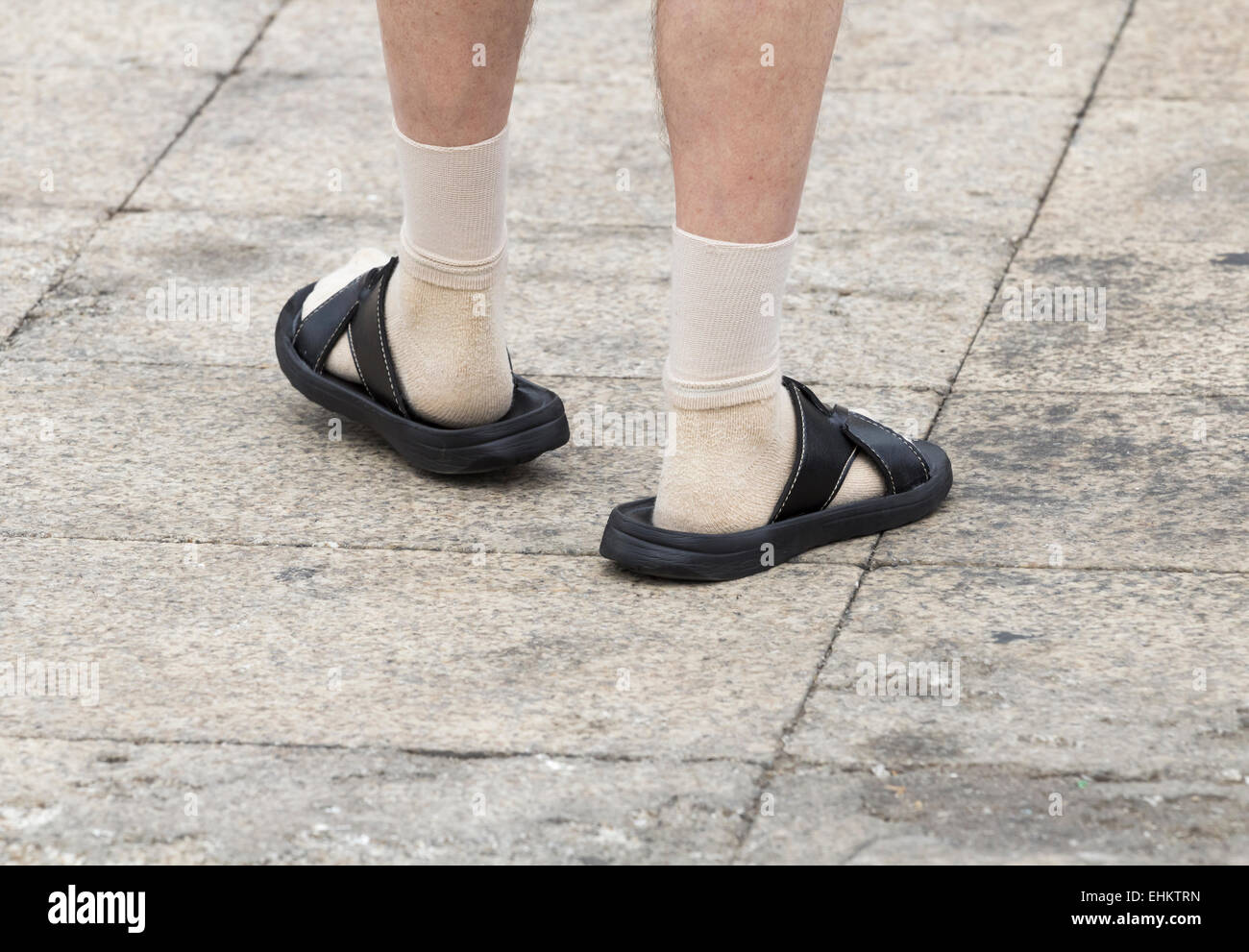 Man wearing socks and sandals on holiday. Stock Photo