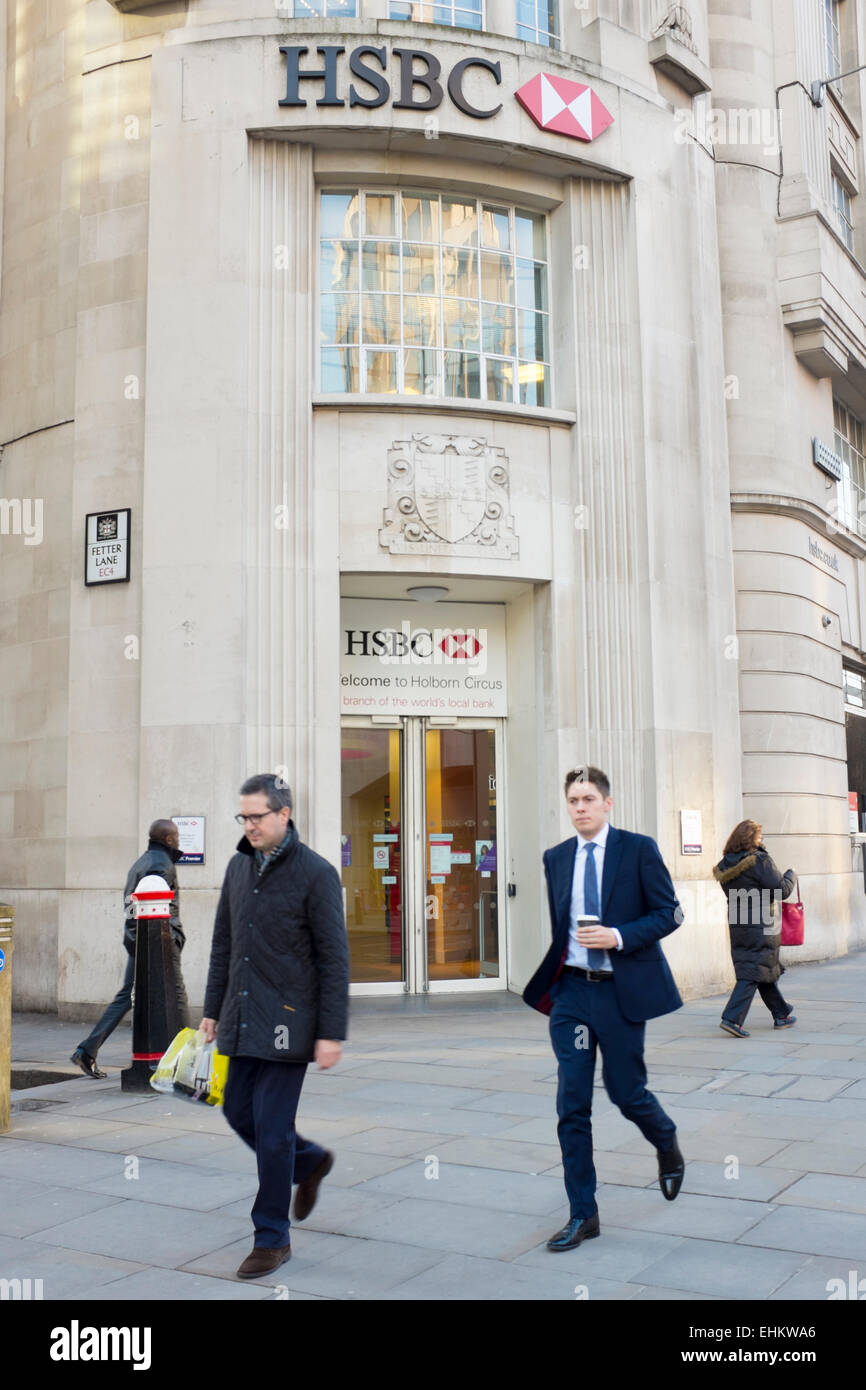 HSBC Bank branch with city workers walking past Stock Photo