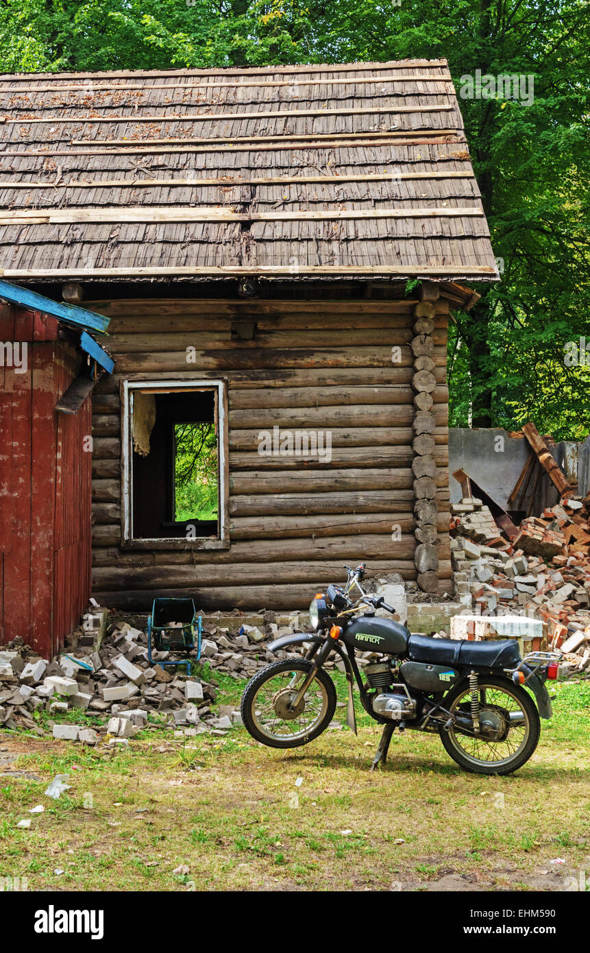 Old motorcycle near the abandoned disassembling rural house Stock Photo ...