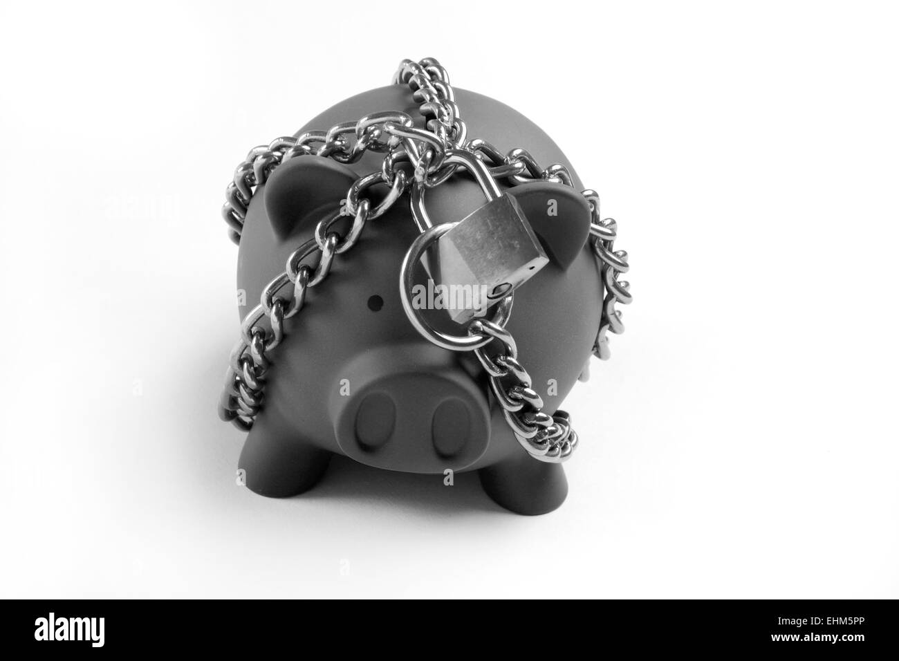 Piggy bank tied with the chain Stock Photo