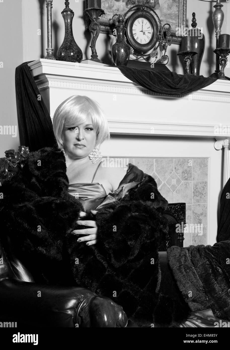 A dramatic portrait of a woman dressed in evening wear and a fur coat - black and white photo Stock Photo