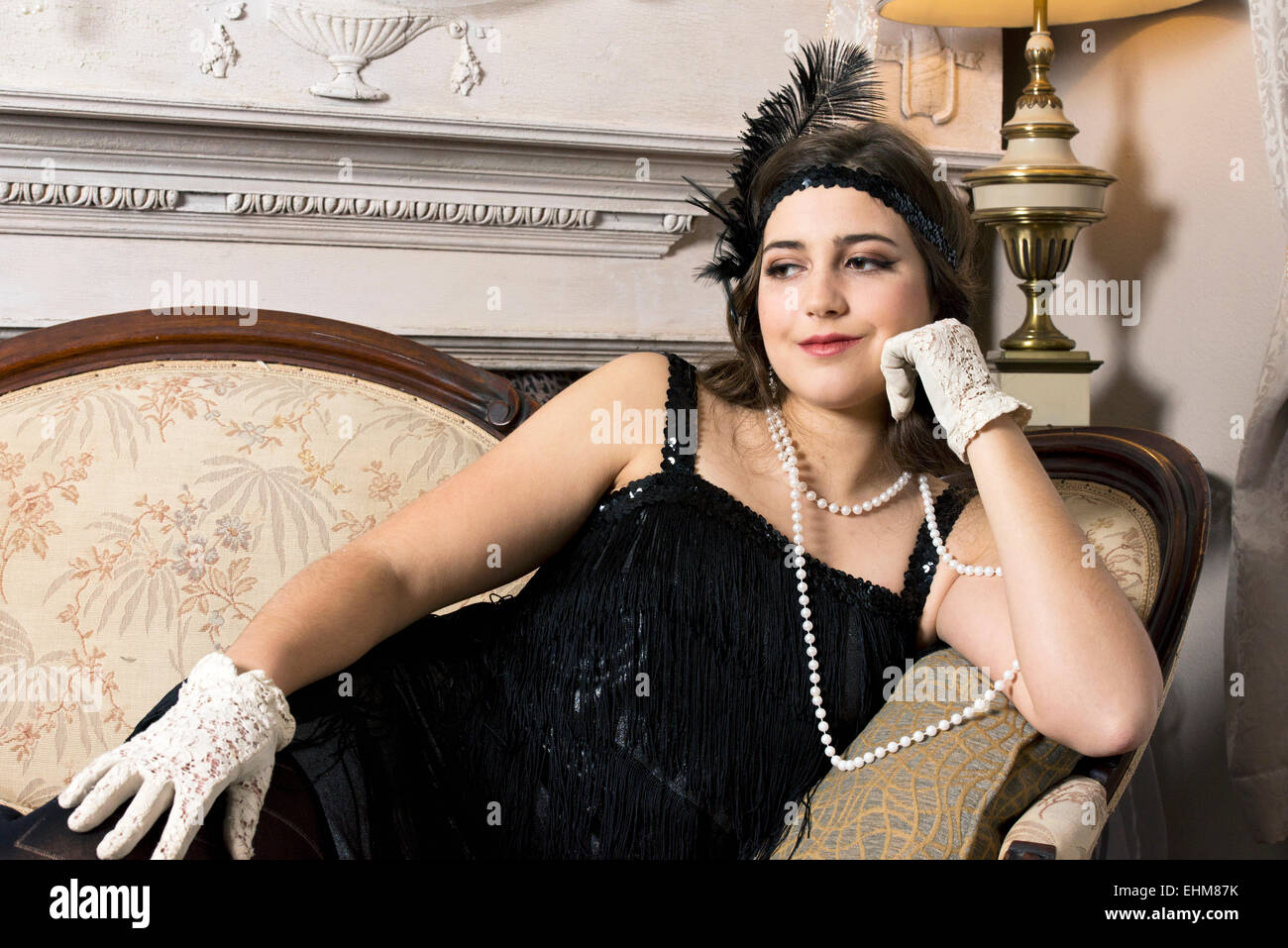 A portrait of a woman dressed in vintage 1920's flapper style clothing Stock Photo
