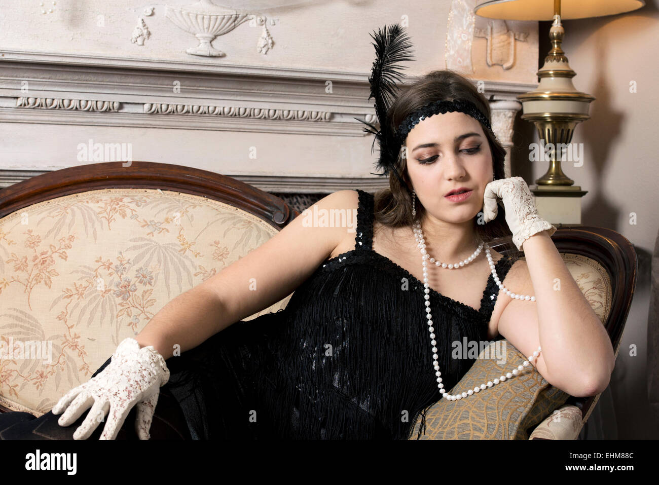 A portrait of a woman dressed in vintage 1920's flapper style clothing Stock Photo