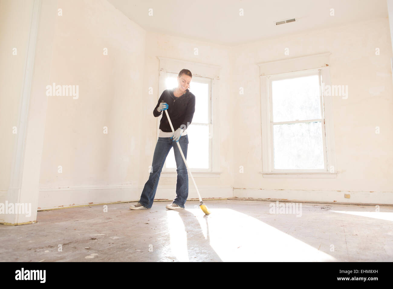 Woman sweeping floor hi-res stock photography and images - Alamy
