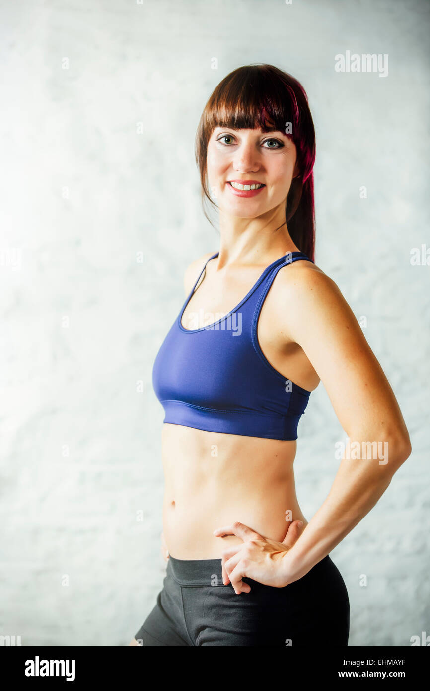Caucasian woman smiling in sports bra Stock Photo