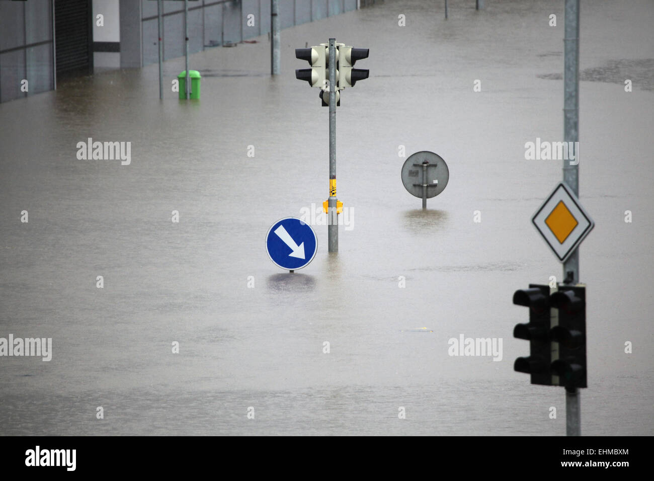 Flooded crossroad with traffic lights and a keep right traffic sign ...