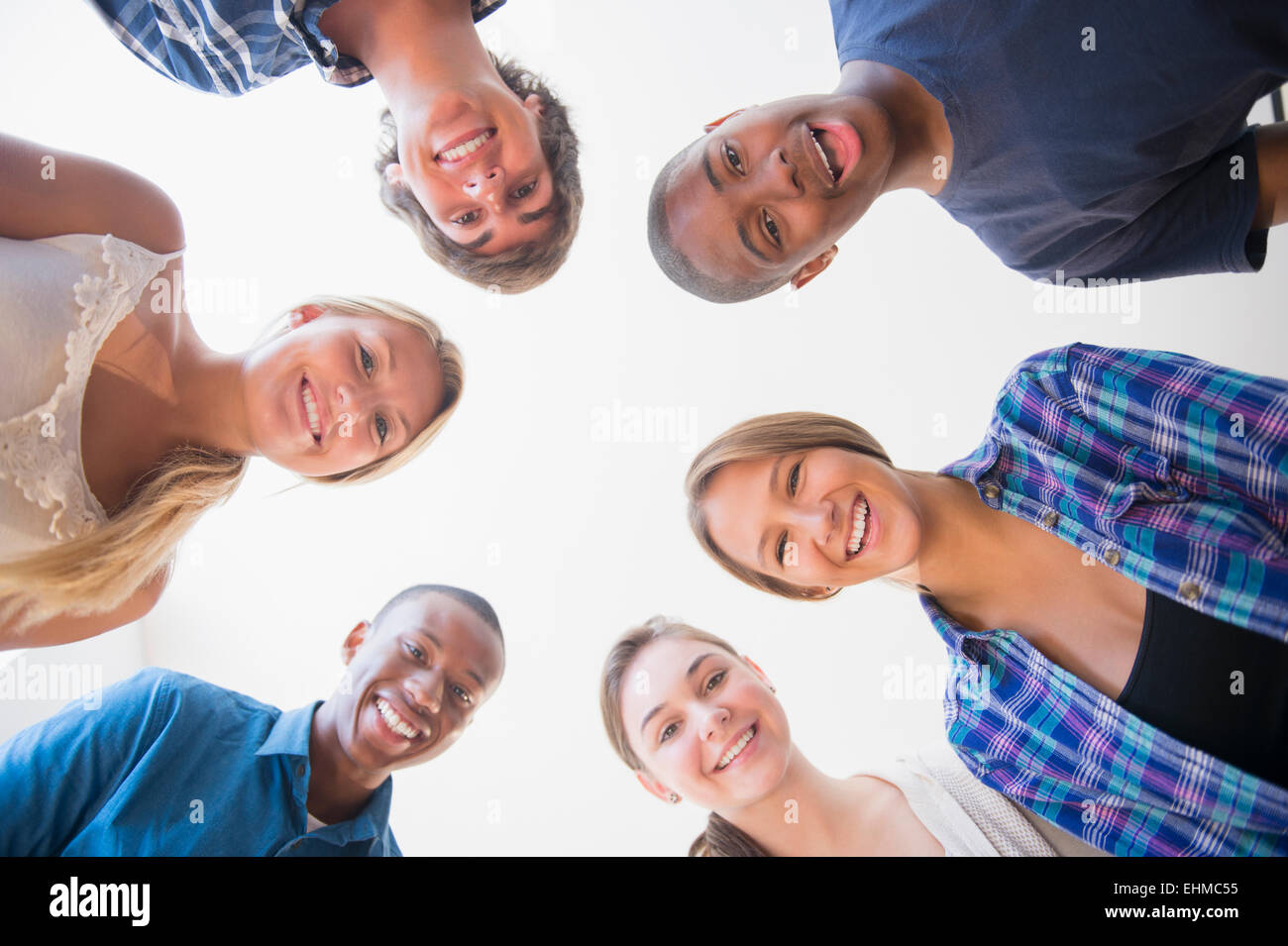 Low angle view of teenagers standing in circle Stock Photo
