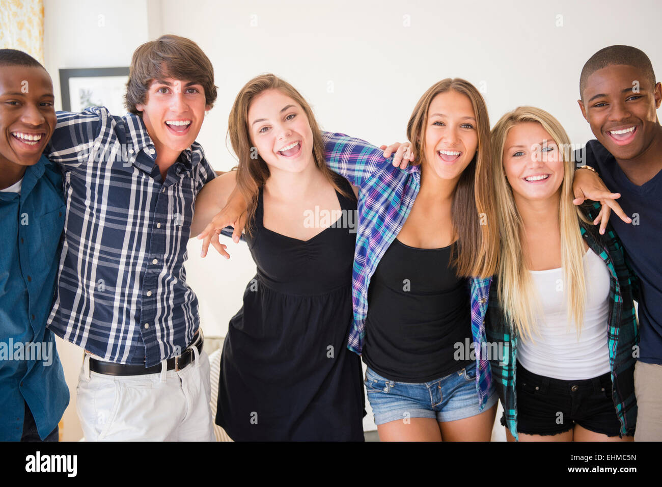 Teenagers smiling in living room Stock Photo