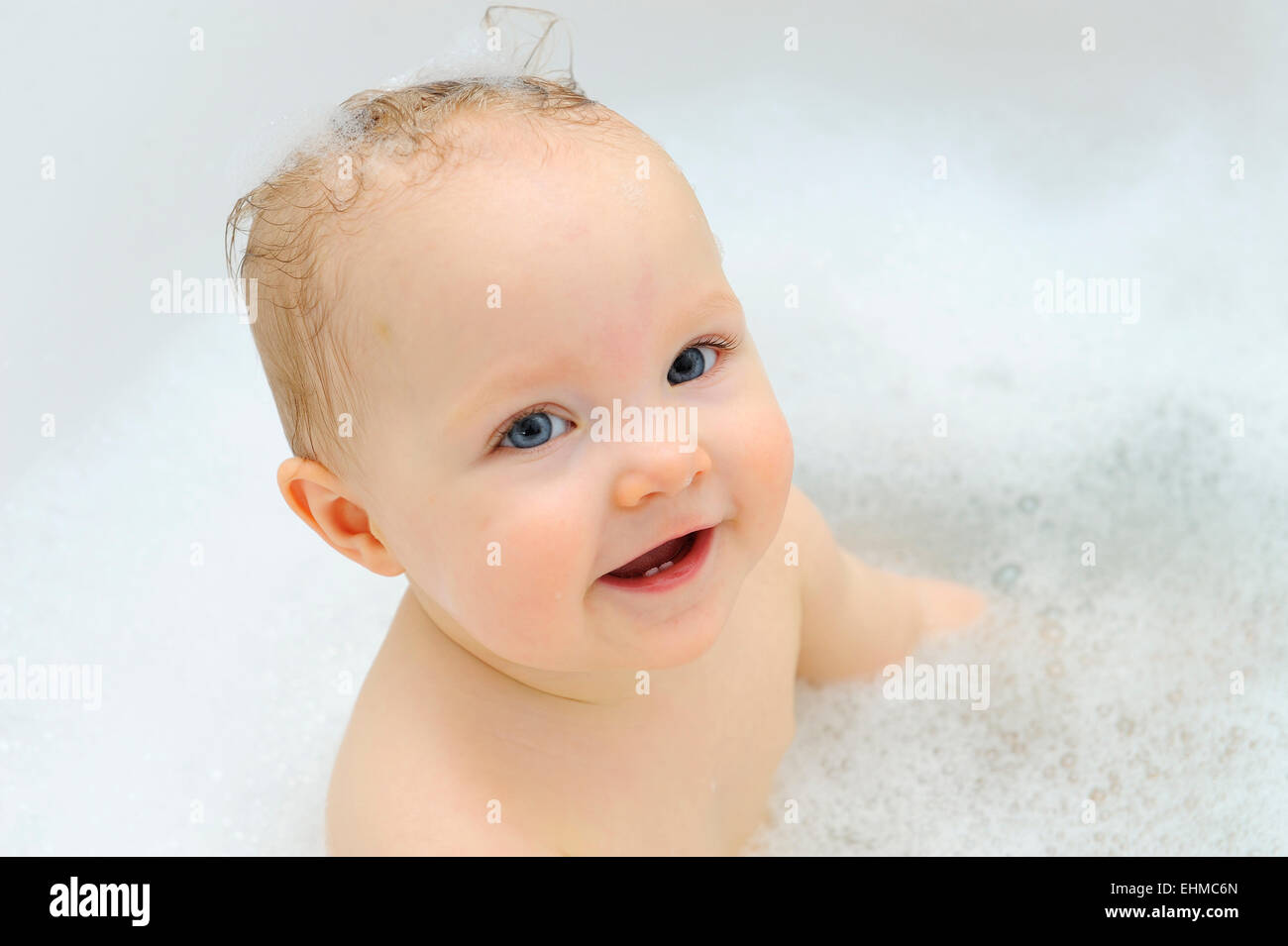 Baby girl, 11 months, while bathing, Germany Stock Photo