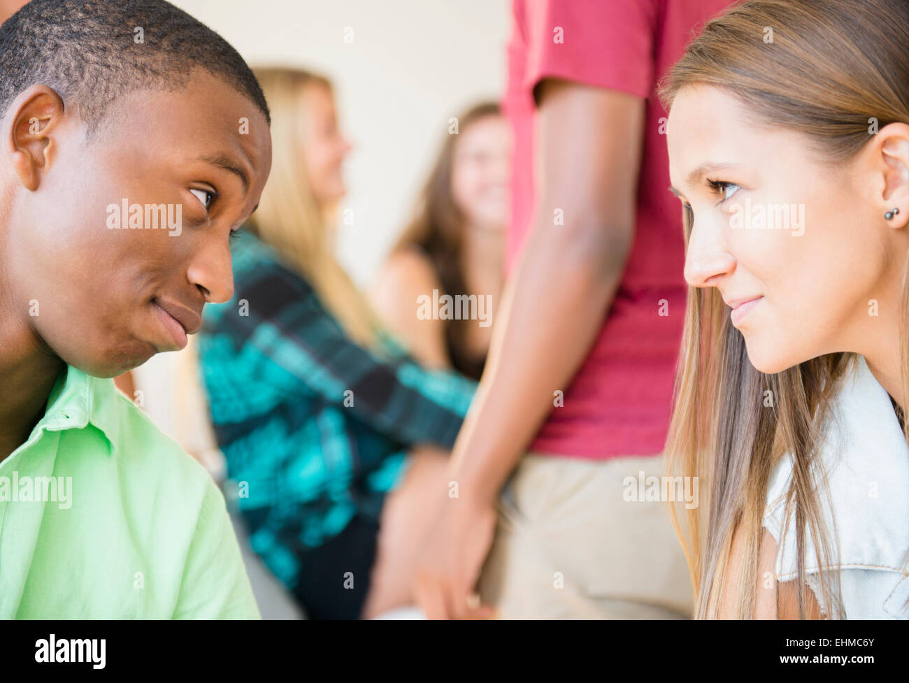 Teenagers face to face at party Stock Photo