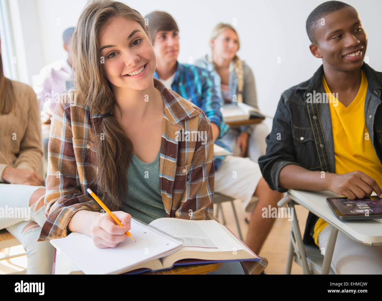 Teenage student smiling in classroom Stock Photo