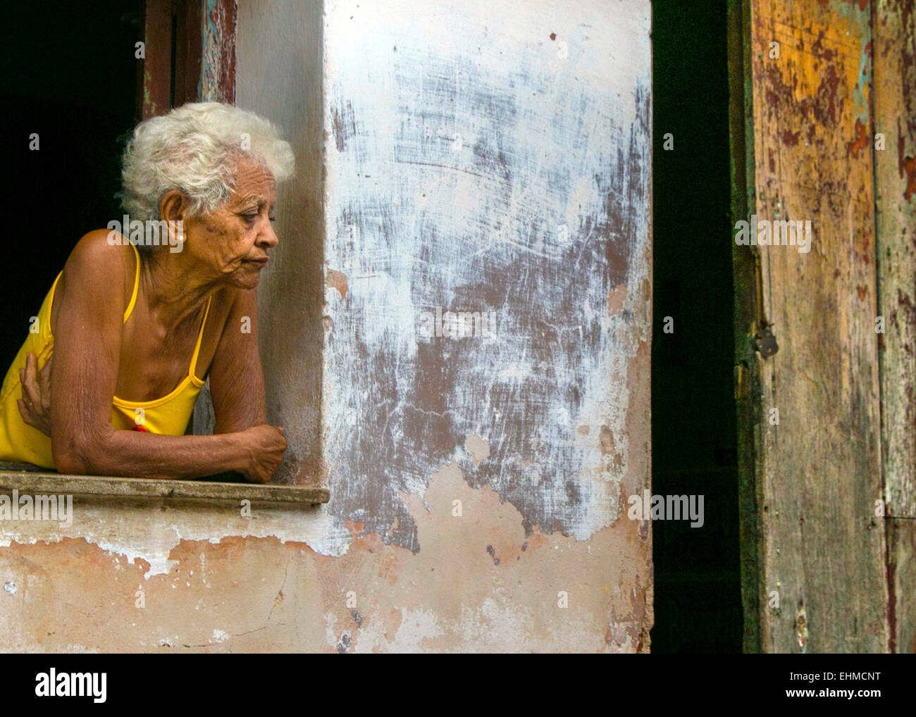 Older cuban women in a window Stock Photo