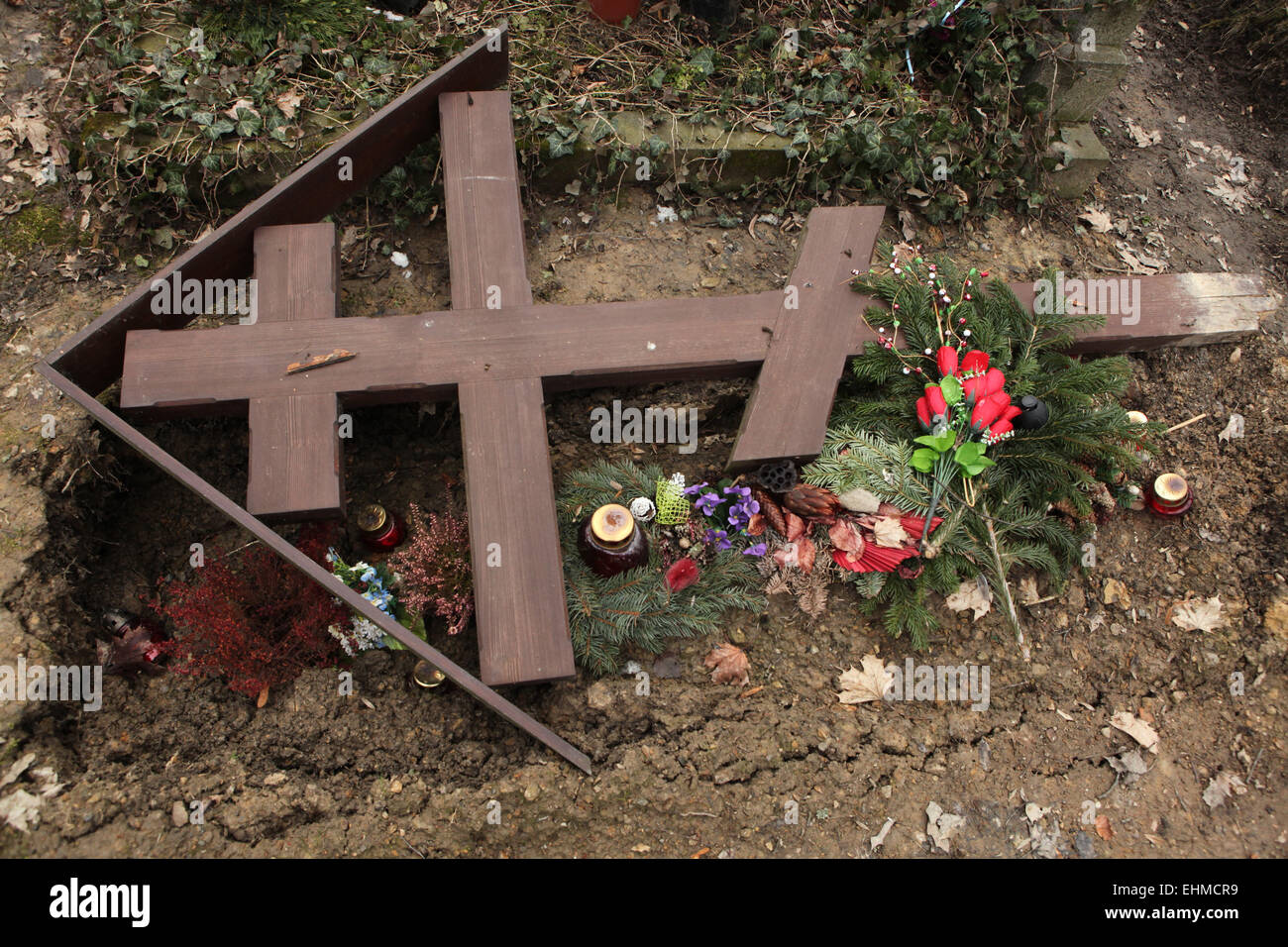 Fallen orthodox cross on an unmarked grave at the Olsany Cemetery in Prague, Czech Republic. Stock Photo