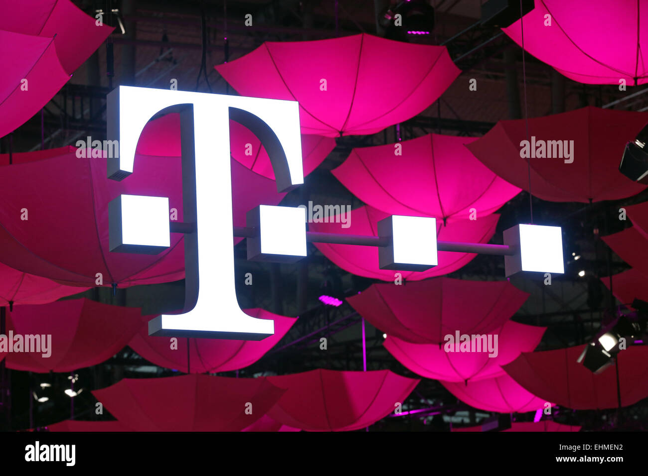CeBIT computer fair 2015 in Hannover, Germany. Logo of German Telekom at their stand with hundreds of pink umbrellas forming a roof Stock Photo