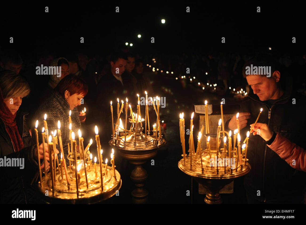 Orthodox believers light candles during an Orthodox Easter night