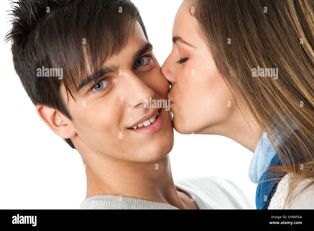 Close up portrait of girl kissing boy on cheek.Isolated on white Stock ...