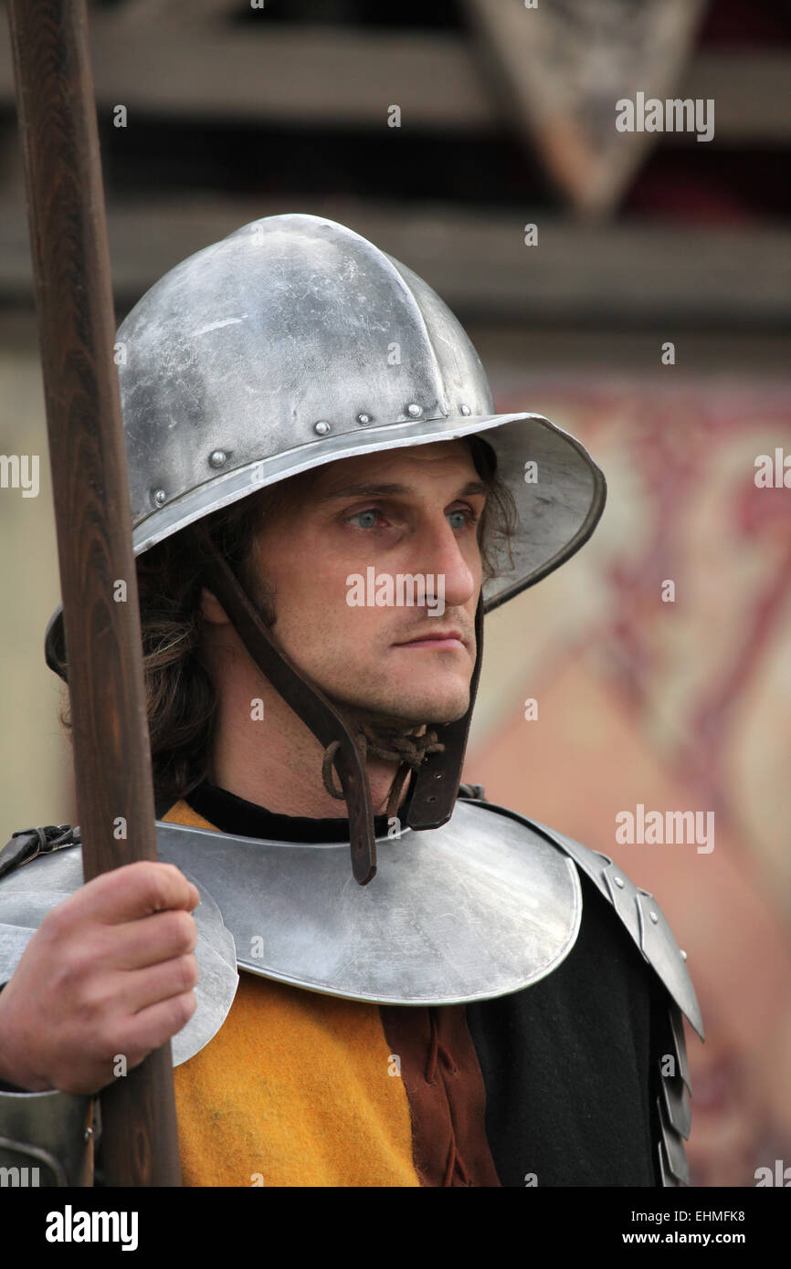 Background actor dressed as a medieval guard attends the filming of the