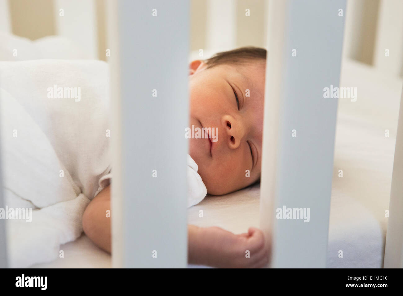 Mixed race baby sleeping in crib Stock Photo Alamy