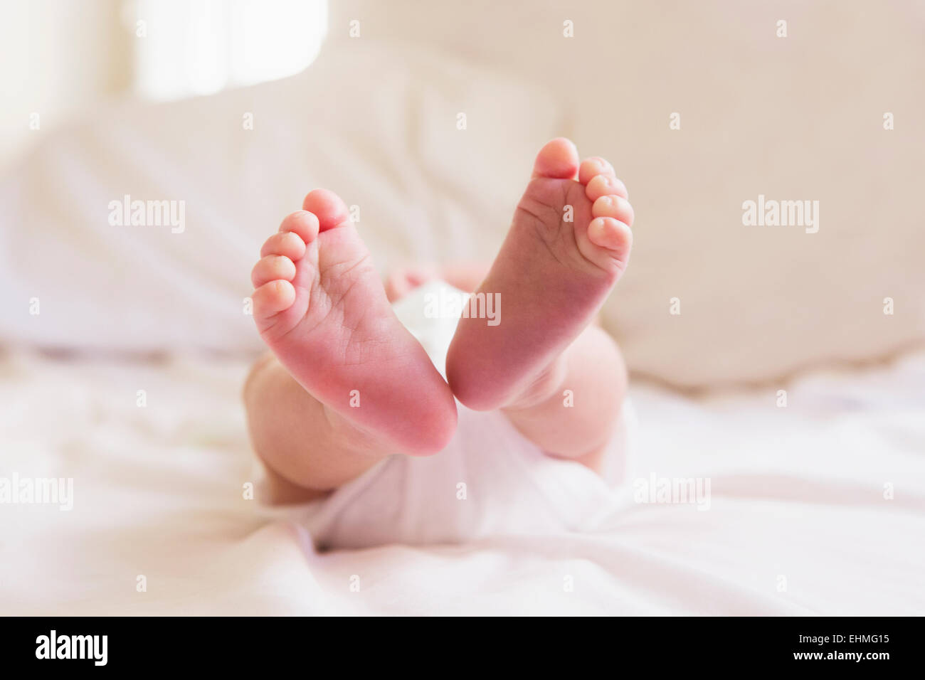 Close up of feet of mixed race baby Stock Photo