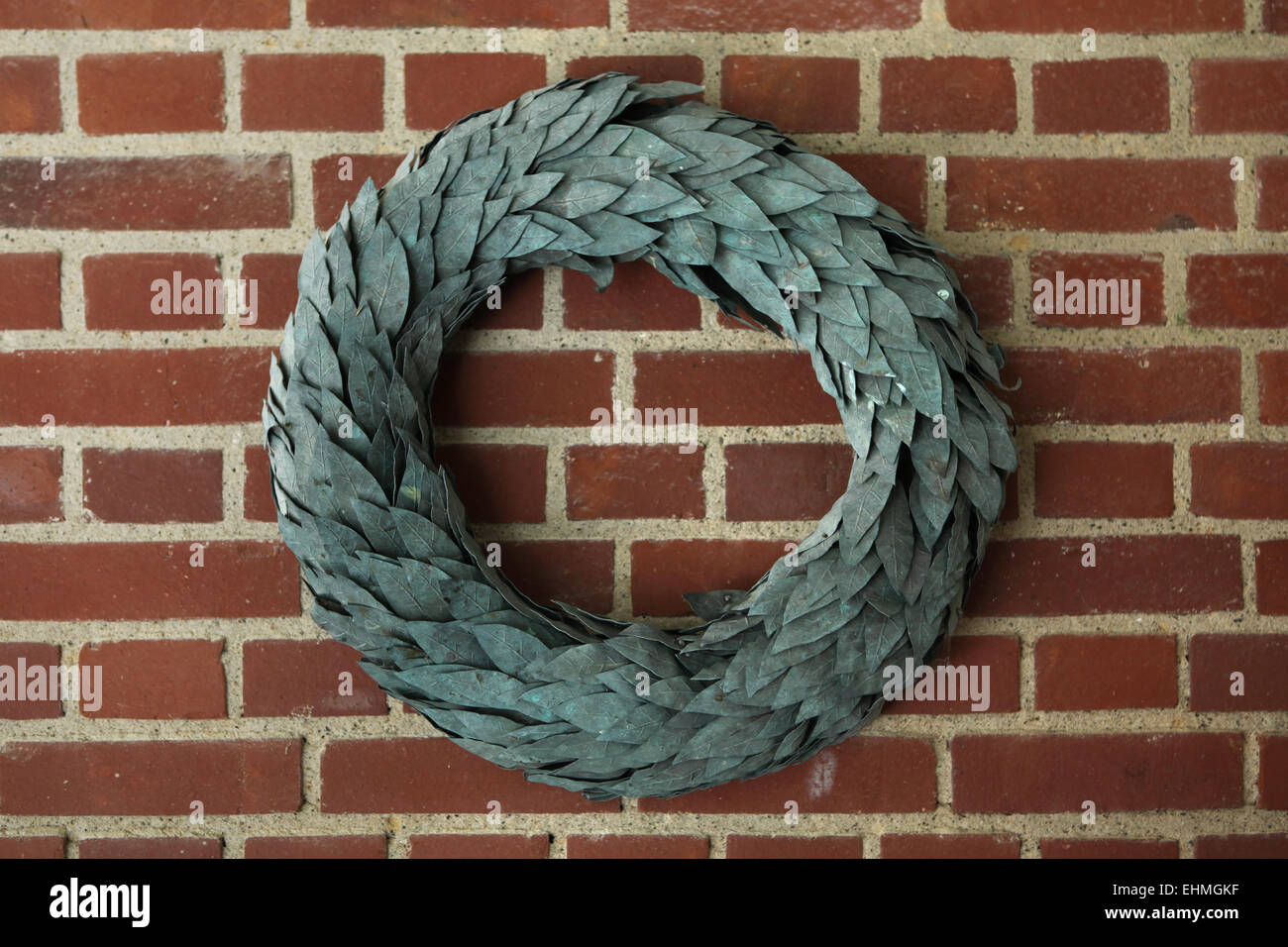 Laurel wreath on the brick wall. Stock Photo