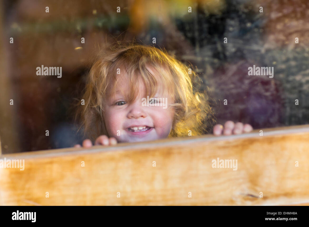 Caucasian baby smiling and looking out window Stock Photo Alamy
