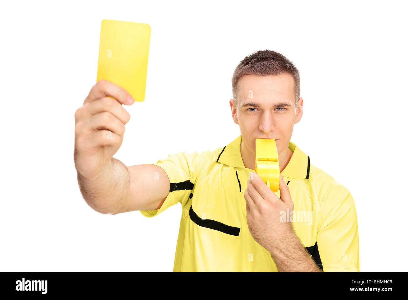 Referee showing yellow card and blowing huge whistle isolated on white background Stock Photo