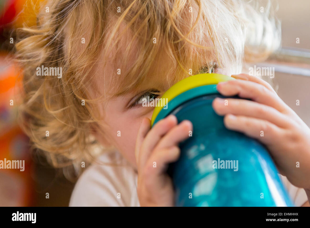 Caucasian baby drinking water from cup Stock Photo