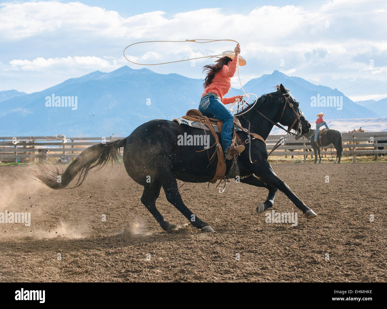 Caucasian woman using lasso on horse at rodeo Stock Photo