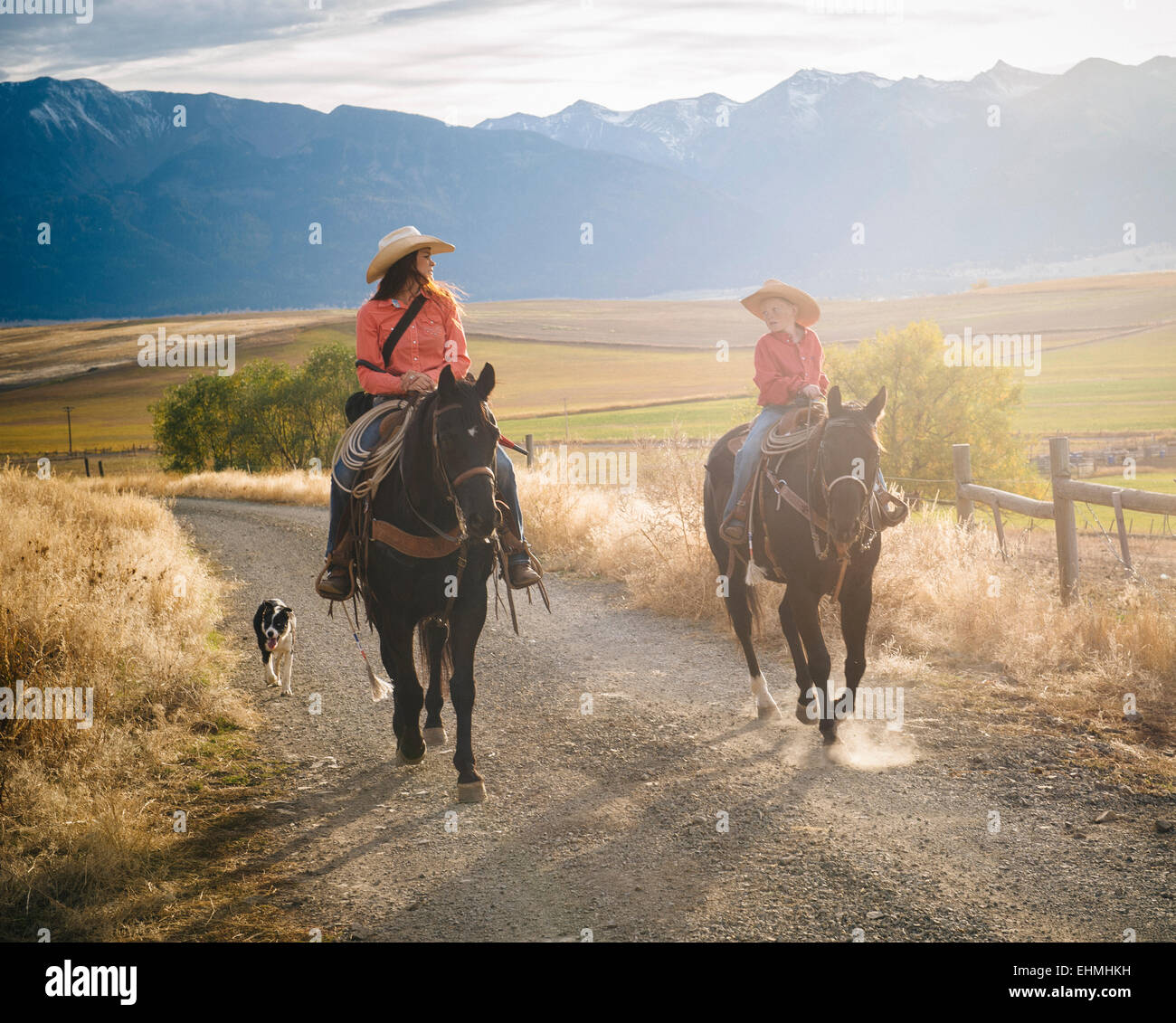 Caucasian mother and son riding horses on ranch Stock Photo
