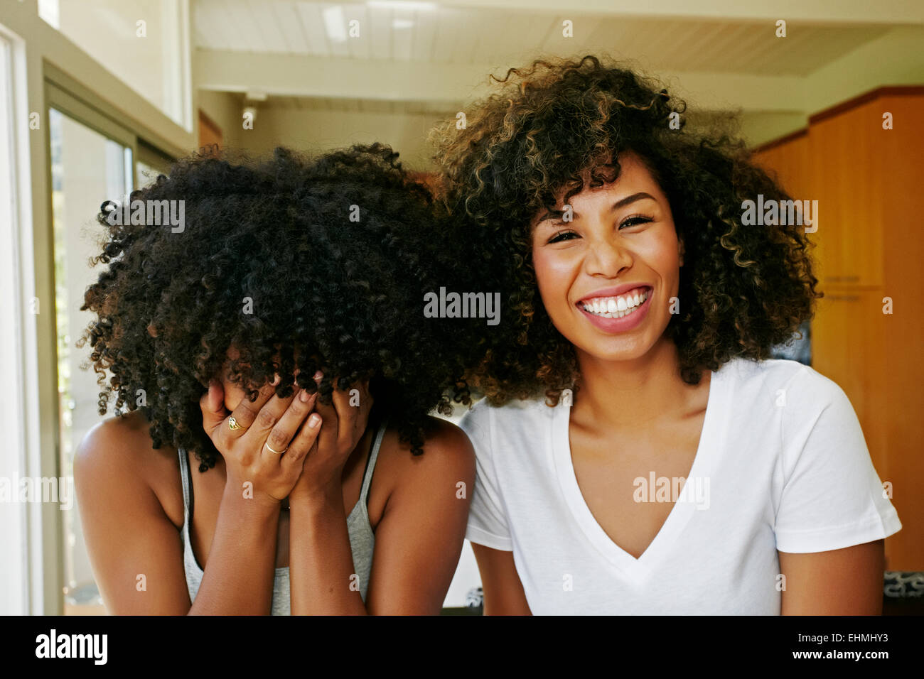 Mixed race women laughing Stock Photo