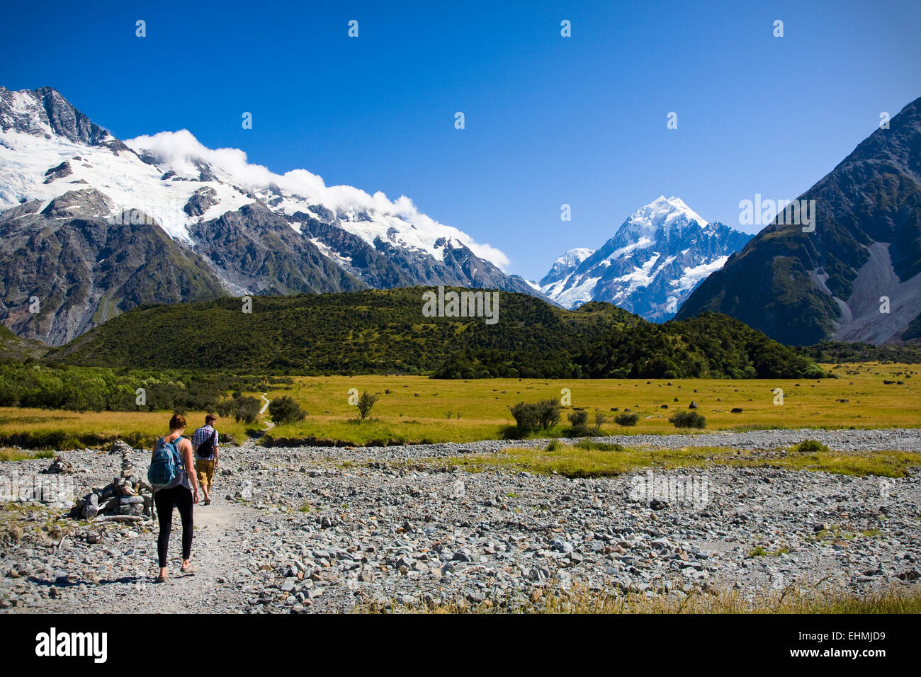 Hikers in Aoraki National Park with Mount Cook behind, South Island, New Zealand Stock Photo