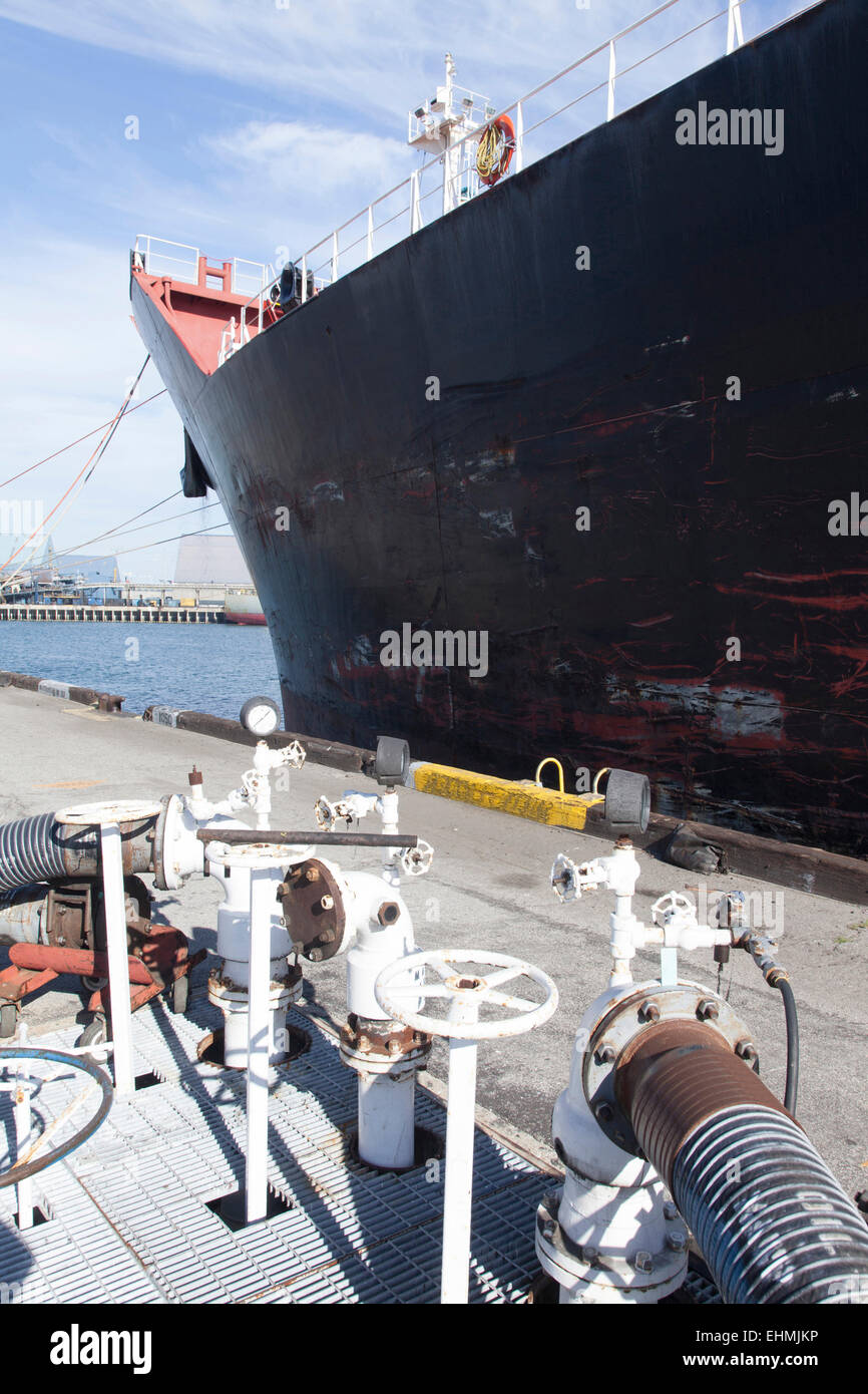 Oil tanker ship docked in industrial harbor Stock Photo
