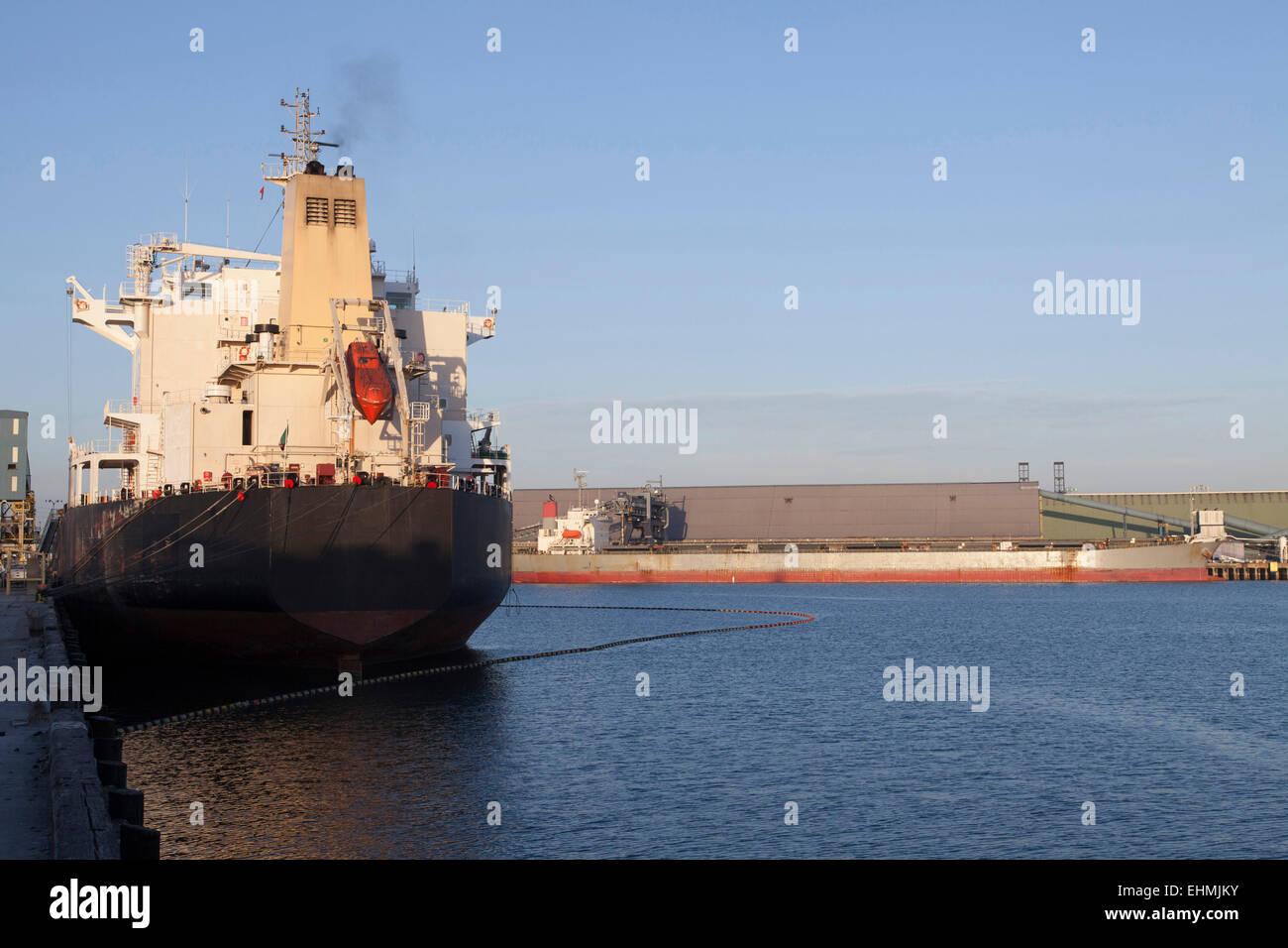 Oil tanker ship docked in industrial harbor Stock Photo