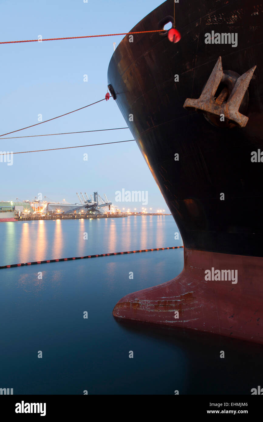 Close up of bow of ship docked in industrial harbor Stock Photo