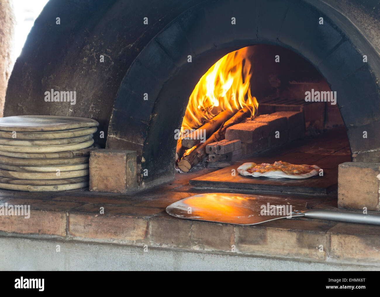 pizza making fire wood burn fire place sauce cooking Stock Photo Alamy