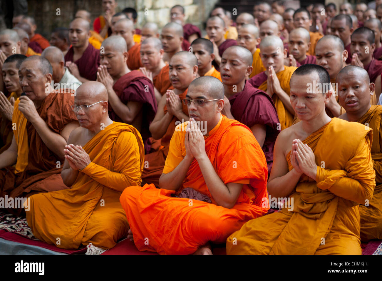 International Buddhist monks pray at Mahabodhi temple, Bodh Gaya, India, a day after terrorism bomb blast on 7 July 2013. Stock Photo