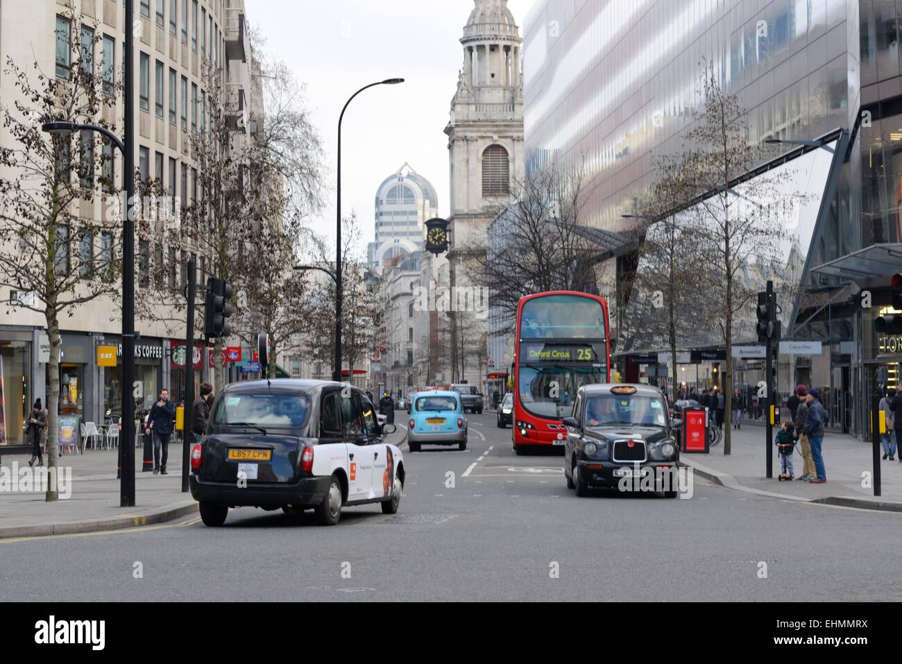 Black cabs, red bus and traffic between offices on Cheapside, City of London, UK Stock Photo