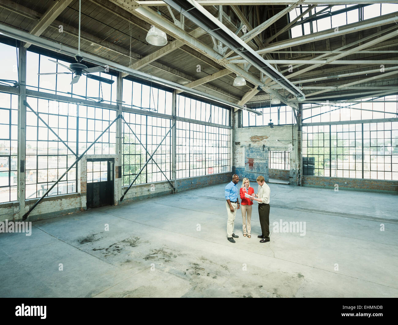 Business people talking in empty warehouse Stock Photo