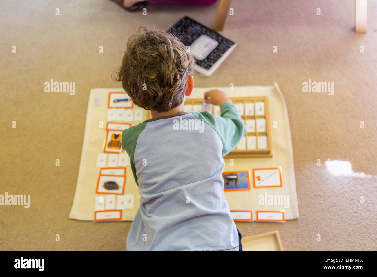 Caucasian boy arranging cards in classroom Stock Photo