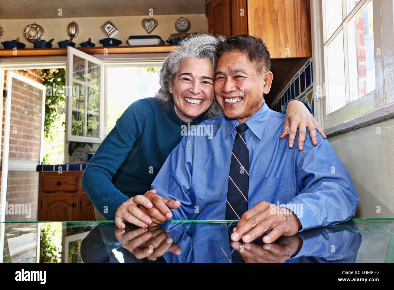 Couple smiling in kitchen Stock Photo