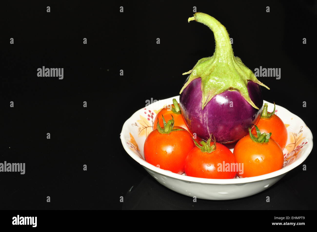 purple egg plant and red tomatoes Stock Photo