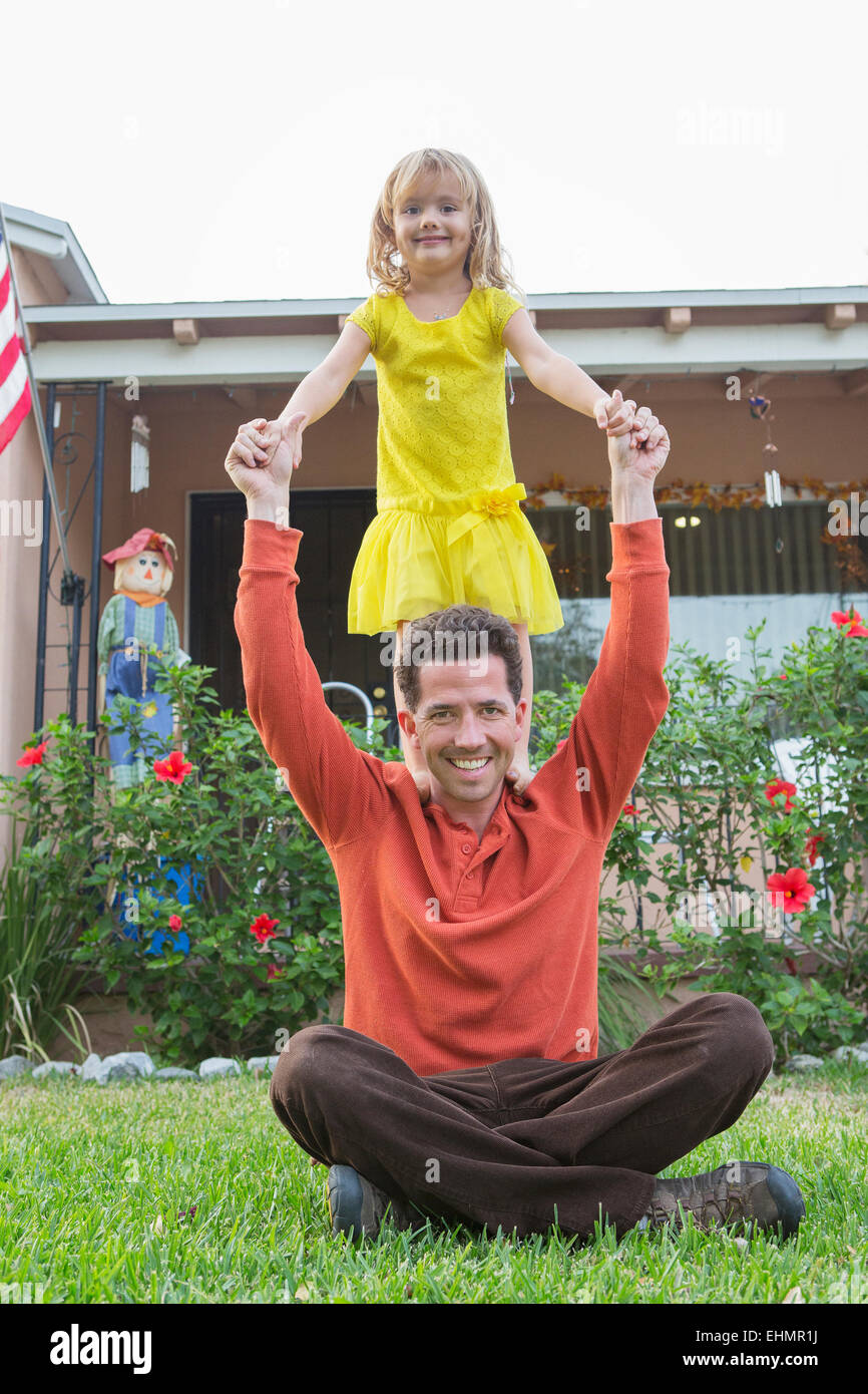 Caucasian father and daughter playing in backyard Stock Photo