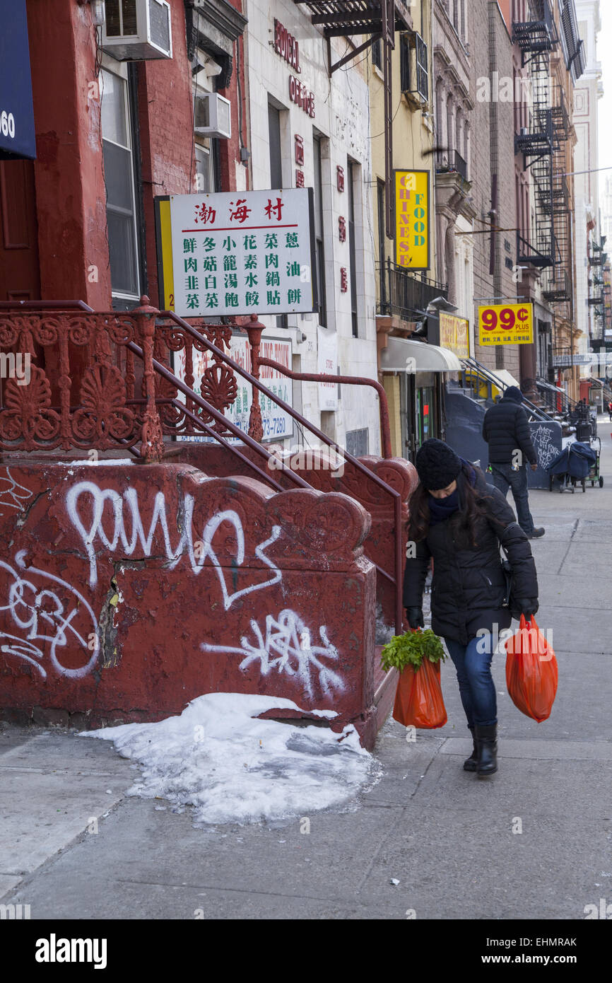 Woman walking with groceries in Chinatown, New York City. Stock Photo
