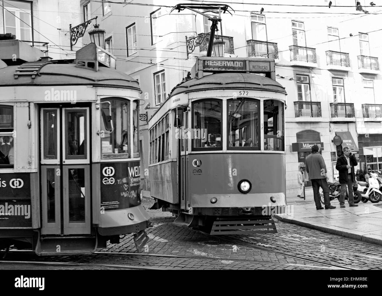Portugal, Lisbon: Black and white version of two historic trams meeting at the center Stock Photo