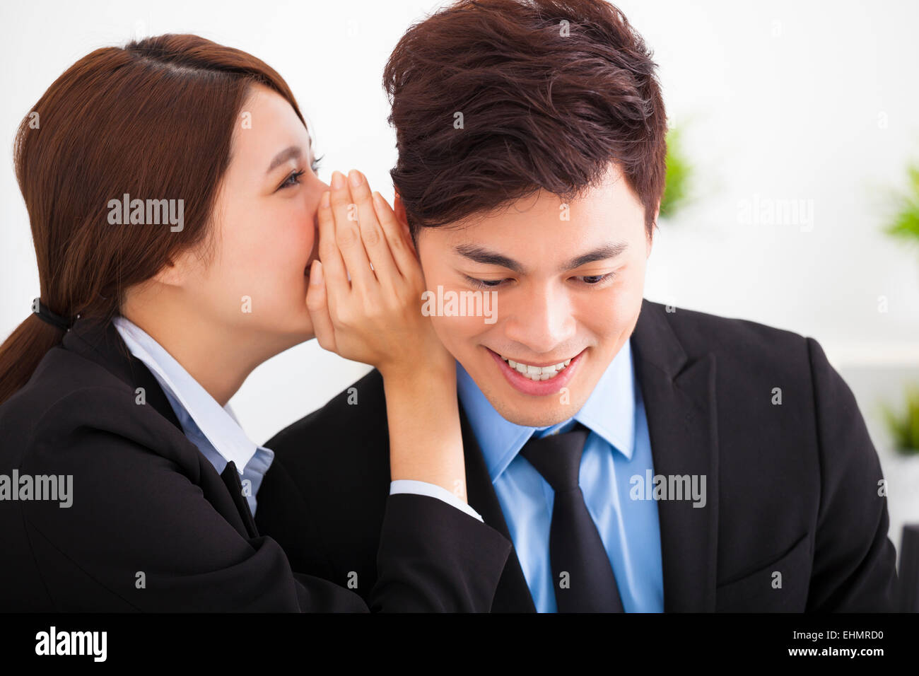 business gossip between businesswoman and businessman Stock Photo