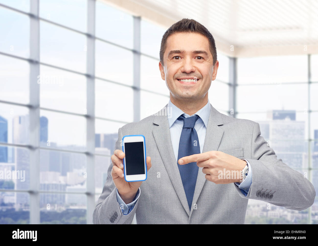 happy businessman showing smartphone screen Stock Photo - Alamy