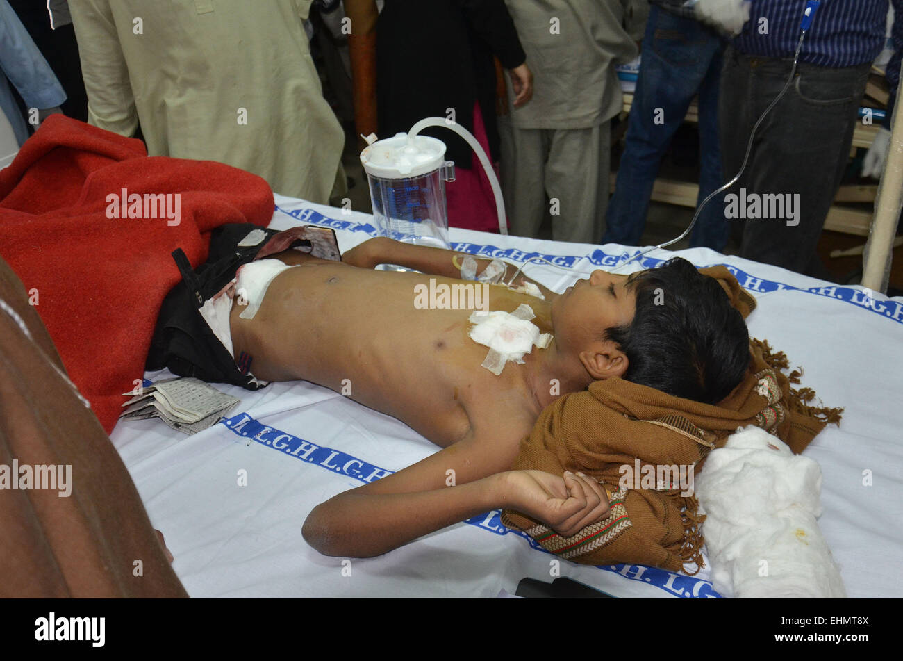 Lahore, Pakistan. 15th March, 2015. Victims brought in the hospital. The mob called suspects in aiding the suicide bombers nearby the scene of an attack on a church in Lahore, Pakistan, 15 March 2015. Two Taliban suicide bombers blew themselves up outside two churches in the impoverished Yohana Abad sector of eastern Lahore during Sunday mass, killing at least 11 worshipers and wounding several others, officials said, in the latest attack against religious minorities. Credit:  PACIFIC PRESS/Alamy Live News Stock Photo