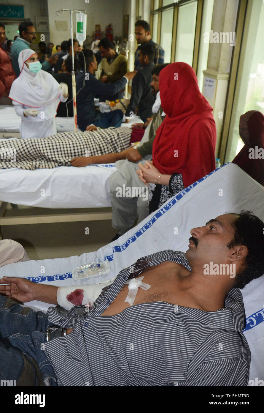 Lahore, Pakistan. 15th March, 2015. Victims brought in the hospital. The mob called suspects in aiding the suicide bombers nearby the scene of an attack on a church in Lahore, Pakistan, 15 March 2015. Two Taliban suicide bombers blew themselves up outside two churches in the impoverished Yohana Abad sector of eastern Lahore during Sunday mass, killing at least 11 worshipers and wounding several others, officials said, in the latest attack against religious minorities. Credit:  PACIFIC PRESS/Alamy Live News Stock Photo