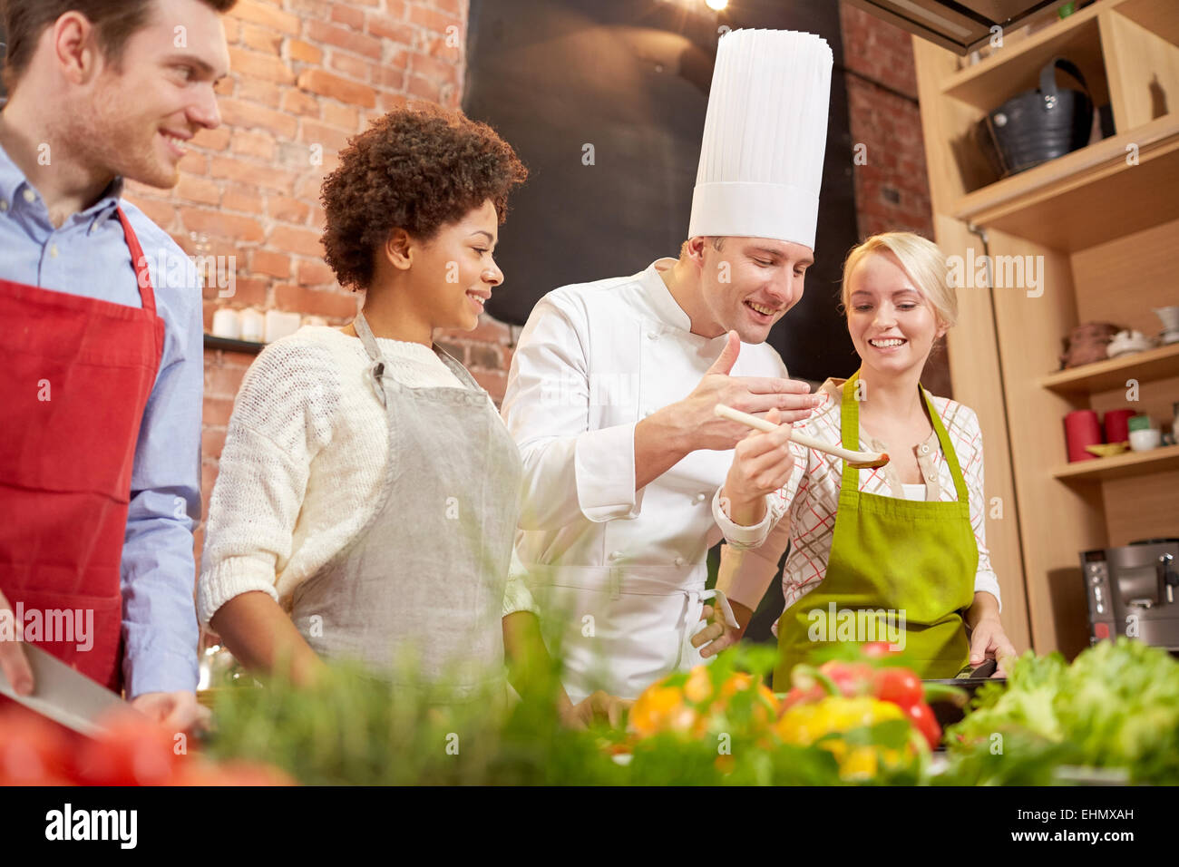 happy friends and chef cook cooking in kitchen Stock Photo - Alamy