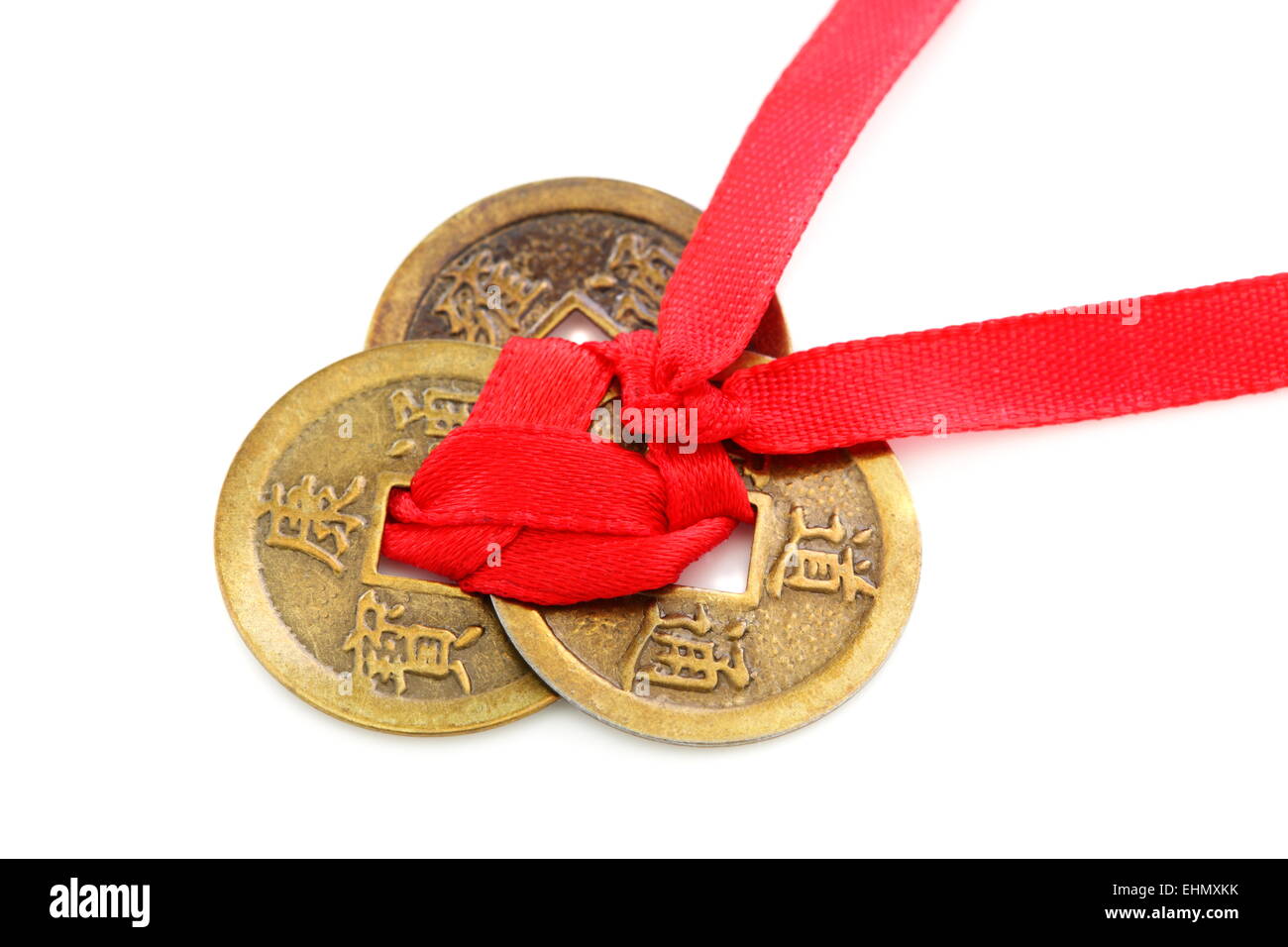 Three Chinese coins tied with red ribbon. Stock Photo